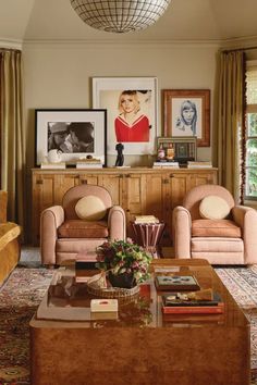 a living room filled with furniture and pictures on the wall