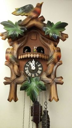 a cuckoo clock with two birds on it's face