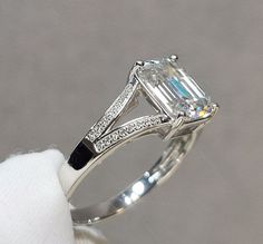 an engagement ring with a large emerald cut diamond