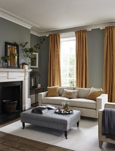 a living room with two couches and a coffee table in front of a fireplace