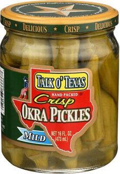 pickles in a glass jar with the label talk of texas crisped okra pickles