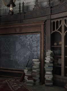 there is a chalkboard in the corner of this room with many books on it