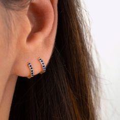 "An all-time bestseller with dark blue sapphire zirconia stones. Elegant and classic, these tiny huggie hoops prong-set with brilliant zirconia gemstones are a beautifully dainty addition to your everyday lineup. Subtle, versatile and perfect to mix and match with other earrings. * D E T A I L S * ∙ Sold individually (1 earring) or as a pair (2 earrings) ∙ Material: .925 Sterling Silver or 18K Gold Plated over .925 Sterling Silver ∙ Stone: Blue Zirconia ∙ Dimensions: Hoop Diameter: 10mm // Width Minimalist Blue Huggie Hoop Earrings, Blue Huggie Hoop Earrings, Blue Small Hoop Huggie Earrings, Hypoallergenic Blue Small Hoop Huggie Earrings, Blue Hypoallergenic Small Hoop Huggie Earrings, Blue Minimalist Huggie Hoop Earrings, Blue Minimalist Hoop Huggie Earrings, Elegant Blue Huggie Earrings For Everyday Wear, Blue Huggie Hoop Earrings For Pierced Ears