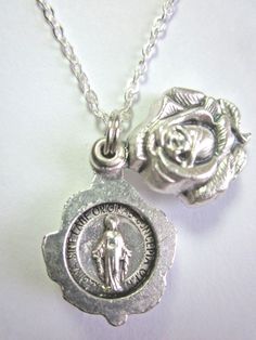 "Miraculous Medal Locket Style Rose Slide Pendant Necklace Rose opens to reveal both sides of a Miraculous Medal. Rose slide medal 3/4\" tall, 1/2\" wide silver tone metal made in Italy 20\" Silver plated 1.75mm cable chain spring ring clasp made in U.S.A. Gift boxed Prayer card included image detail shown" Miraculous Medal, Necklace Rose, Prayer Cards, Spring Rings, Cable Chain, Pocket Watch, Locket, Silver Tone, Gift Box