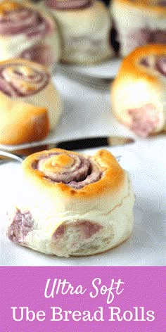 a close up of bread rolls on a plate with the words ultra soft ube bread rolls