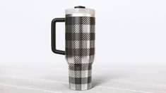 a black and white checkered coffee mug