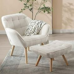 a white chair and footstool sitting on top of a rug