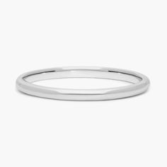 a plain white gold wedding ring with a thin band on the outside, and a slight edge