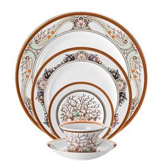 an ornately decorated dinner set with orange accents