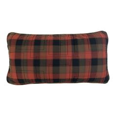 an orange and black plaid pillow on a white background