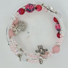 These handmade bracelets with lots of bangles that are easy to wear and simply wrapped around the wrist with no difficult-to-attach clasps. With beautiful, high quality materials, including glass beads, pewter spacers, and adorable charms, 3 Loop Memory Bracelet with an Angel & a Cross Charms on each end... Stainless steel hypoallergenic memory wire to create a five loop, 3 loop or 1 loop bracelet which will easily adjust to the size of your wrist, and is accented with charms on each end. Th Memory Bracelet, Memorial Bracelet, Memory Wire Bracelet, Memory Wire Bracelets, Bracelet Gemstone, Elegant Bracelet, Memory Wire, Wire Bracelet, Cross Charms