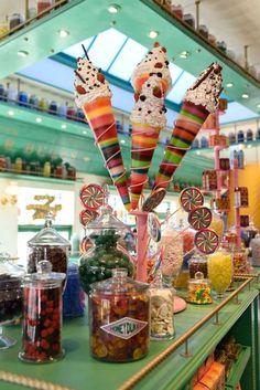 the candy bar is filled with lots of colorful candies and lollipops