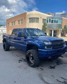 a blue truck parked in front of a building