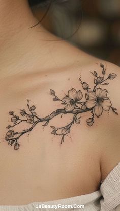 a woman's shoulder with flowers on it