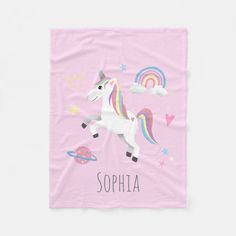 a pink towel with a unicorn on it and the words sophia in rainbows