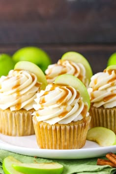 cupcakes with caramel icing and apple slices on a plate