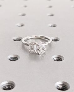 a diamond engagement ring sitting on top of a table