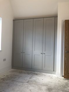 an empty room with several cupboards in it