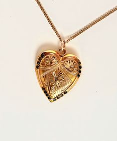 This is a rare beautiful vintage antique 14K gold filled heart locket with scroll design of Fleur-de-lis, floral etched and surrounded 16 stones around the edge. The locket has amazing engraved flowers. Inside the locket has a frame for picture. The backside is plain. This locket is charming piece of jewelry that is sure to steal your heart. A condition is excellent, with no damages or repairs. It hangs from 18" chain necklace that is marked 14K gold filled. Large locket measures 1 1/8" X 1" . Cheap Vintage Gold Locket Necklace, Heirloom Jewelry For Valentine's Day, Traditional Yellow Gold Keepsake Jewelry, Traditional Yellow Gold Jewelry For Keepsake, Victorian Filigree Locket Necklace In Yellow Gold, Victorian Yellow Gold Locket Necklace With Filigree, Victorian Filigree Yellow Gold Locket Necklace, Victorian Medallion Jewelry With Heart Charm, Antique Heart-shaped 14k Gold Necklace