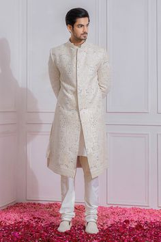 Off white sherwani with sequin and floral embroidery, mandarin collar and full sleeves. 
Component: 1
Pattern: Embroidered
Type Of Work: Sequin
Neckline: Mandarin
Sleeve Type: Full Sleeves
Fabric: Pure Georgette, Cotton Silk
Color: White
Other Details: 
Sequin work
Note: Churidar and inner kurta worn by the model is not for sale
Occasion: Groom,Wedding - Aza Fashions Cream Sherwani With Chikankari Embroidery And Long Sleeves, Designer Cream Sherwani With Long Sleeves, Cream Long Sleeve Sherwani With Chikankari Embroidery, Designer Cream Long Sleeve Sherwani, Designer Long Sleeve Cream Sherwani, White Straight Kurta Bandhgala For Wedding, Designer Off-white Sherwani For Festive Occasion, Off White Sherwani With Zari Work And Long Sleeves, White Sherwani With Resham Embroidery And Long Sleeves