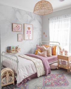 a bedroom with pink and white decor in it