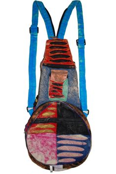 the back of a backpack with different colored patches on it and straps hanging from each side