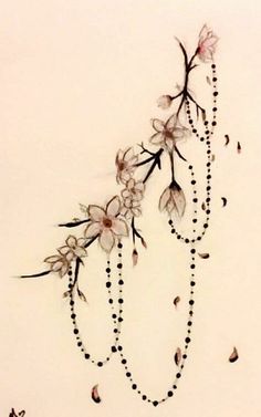 a drawing of flowers and beads hanging from the side of a white wall with a black beaded necklace on it