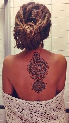 a woman with a tattoo on her back