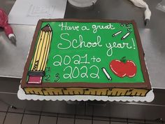 a cake with writing on it that says thank a great school year, and an apple