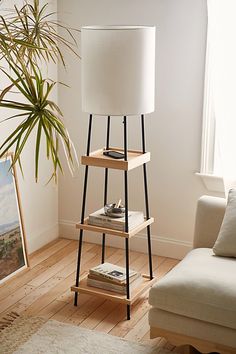 a living room with a couch, table and lamp