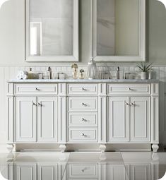 a bathroom with two mirrors and double sinks