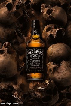 a bottle of jack daniels whiskey surrounded by skulls