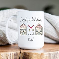 a white coffee mug sitting on top of a wooden table