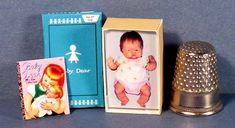 an old fashioned thimble and other items are sitting on the table next to each other