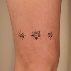 a woman's leg with three snowflakes on it