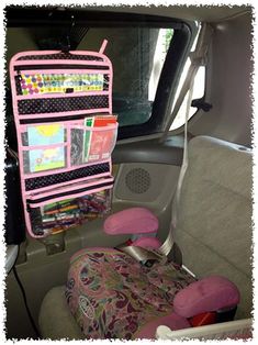 the interior of a car with pink and black items on it's back seat