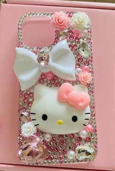 the hello kitty phone case is decorated with swarongs and flowers, including roses