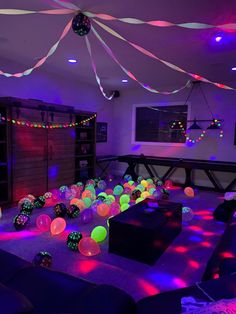 a room filled with lots of balloons and lights