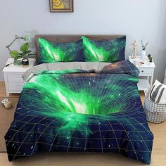 a green and blue comforter set on a bed