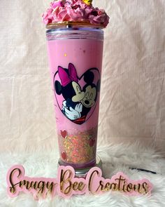 a cup with pink frosting and minnie mouse on it