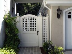 an entrance to a house with a white gate