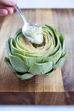 an artichoke is being spooned into the center of a piece of artichoke