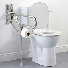 a toilet with a hand rail attached to the back of it and a roll of toilet paper in front of it