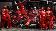 ferrari mechanics work on the car of lewis