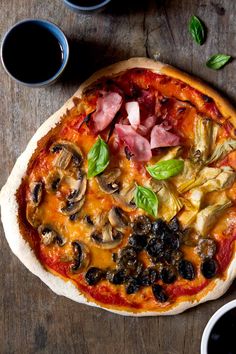 a pizza sitting on top of a wooden table