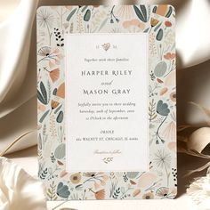 a wedding card with an elegant floral design on it and the words harper riley and mason gray