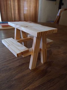 a wooden bench sitting on top of a hard wood floor