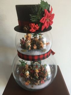 three snow globes are stacked on top of each other with christmas decorations in them