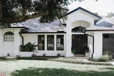 a white house with black doors and windows