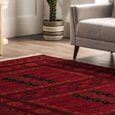 a living room with a couch, chair and rug